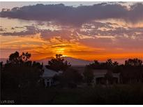 Panoramic mountain views at sunset with orange and yellow skies over the Las Vegas Valley at 3032 Highland Falls Dr, Las Vegas, NV 89134