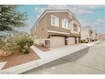 Charming townhome with a two-car garage, neutral stucco, and manicured landscaping at 3312 Speckle Summer Pl # 3, North Las Vegas, NV 89084