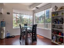 Bright dining area features a glass top table, black chairs, and lovely view at 35 E Agate Ave # 208, Las Vegas, NV 89123