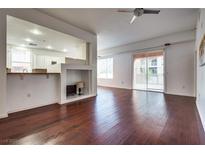 Bright living room featuring hardwood floors, a ceiling fan and sliding glass doors to let the outside in at 35 E Agate Ave # 208, Las Vegas, NV 89123