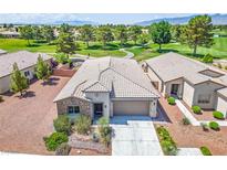 Single-story home featuring desert landscaping, a stone facade, and an attached two-car garage, set on a golf course at 5235 E La Campana Dr, Pahrump, NV 89061