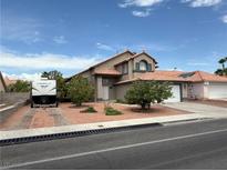Charming home featuring desert landscaping, a multi-car garage, and RV parking on a sunny day at 5517 Rock Creek Ln, Las Vegas, NV 89130