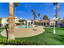 Inviting community pool surrounded by lush landscaping and palm trees on a sunny day at 698 S Racetrack Rd # 1714, Henderson, NV 89015