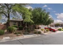 Charming single-story home featuring mature landscaping, brick accents and a vibrant red vintage car at 7126 Mirkwood Ave, Las Vegas, NV 89178