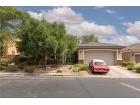 Charming single-story home featuring a two-car garage, stone accents, and mature trees in a well-kept yard at 7126 Mirkwood Ave, Las Vegas, NV 89178