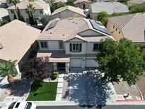 Aerial view of a two-story home with a three-car garage, and desert landscaping at 7821 Red Leaf Dr, Las Vegas, NV 89131