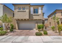 Charming home with a well-manicured front yard, brick driveway, and a two-car garage at 8055 Tank Loop St, Las Vegas, NV 89166