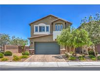Inviting two-story home featuring a well-manicured front yard and charming architectural details at 9208 S Park St, Las Vegas, NV 89178