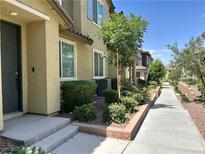 Well-manicured townhome exterior with a lush landscape and inviting walkway at 965 Nevada State Dr # 39102, Henderson, NV 89002