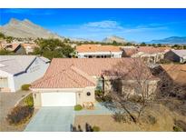Inviting single-story home with tile roof and mountain views at 10628 Mission Lakes Ave, Las Vegas, NV 89134