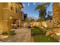 Outdoor living space featuring a mini golf course, grill, fountain, and outdoor seating under decorative string lights at 1272 Olivia Pkwy, Henderson, NV 89011
