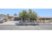 Charming single-story home featuring mature shade trees, brick accents, and a spacious driveway at 1413 Culley St, Las Vegas, NV 89110