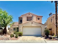 Charming two-story home with a well-manicured front yard and a two-car garage at 1704 Cordoba Canyon St, Las Vegas, NV 89117