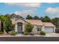 Charming single-story home with a well-manicured lawn, desert landscaping, and a tile roof at 3157 Capetown Way, Las Vegas, NV 89128