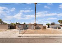 Single-story home with a fenced front yard and low maintenance landscaping in a residential neighborhood at 3200 E Owens Ave, North Las Vegas, NV 89030