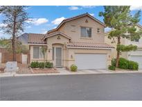 Charming two-story home features a well-maintained front yard, two-car garage, and a red tile roof at 3205 Rainmaker St, Las Vegas, NV 89129