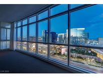Spacious living room featuring floor-to-ceiling windows with panoramic city views and natural light at 4575 Dean Martin Dr # 2607, Las Vegas, NV 89103