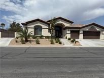 Charming single-story home featuring a well-manicured front yard and a two-car garage at 5855 Boulder Brook Ct, Las Vegas, NV 89149
