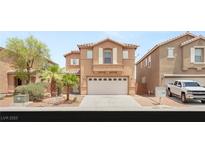 Charming two-story home featuring a two-car garage and desert landscaping in a sunny neighborhood at 6480 Chebec St, North Las Vegas, NV 89084