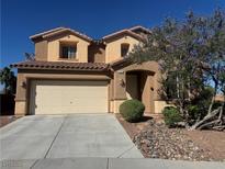 Charming two-story home features a two car garage and landscaped front yard under a clear blue sky at 6756 Sea Swallow St, North Las Vegas, NV 89084