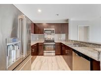 Modern kitchen featuring stainless steel appliances, granite countertops, and dark wood cabinetry at 8255 S Las Vegas Blvd # 1816, Las Vegas, NV 89123