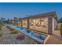 Stunning backyard with modern pool, covered patio, and manicured landscaping perfect for outdoor entertaining at 9 Rue Grimaldi Way, Henderson, NV 89011