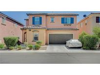 Two-story home showcasing colorful exterior, tidy landscaping, and two-car garage at 1413 Miller Ridge Ave, North Las Vegas, NV 89031