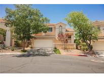 Charming two-story home with a well-maintained front yard and a two-car garage on a sunny day at 2057 Wandering Doe Ln, Las Vegas, NV 89134
