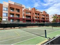 Enjoy a match on the community tennis court with the beautiful condo complex in the background at 23 E Agate Ave # 403, Las Vegas, NV 89123