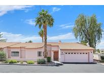 Charming single-story home with a desert landscape, tile roof, and attached two-car garage at 2699 Aldonza Dr, Henderson, NV 89014