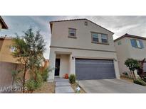 Charming two-story home featuring a neutral color scheme, a two-car garage, and neat landscaping at 3688 Via Mariposa Ave, Las Vegas, NV 89115