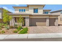 Beautiful two-story home with stone accents, three-car garage, and well-maintained landscaping at 767 Tallgrass St, Las Vegas, NV 89138
