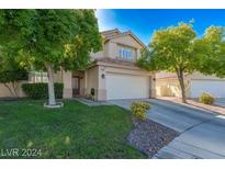 Inviting two-story home featuring a well-manicured lawn and mature trees providing shade and curb appeal at 7837 Fort Ruby Pl, Las Vegas, NV 89128