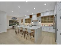 Bright and spacious kitchen features a large island and modern white cabinetry at 2621 Spalding Dr, Las Vegas, NV 89134