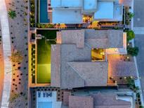 Stunning aerial view of a modern home with a pool, lush landscaping, and a dedicated sport court at 365 Crown Mesa Ave, Las Vegas, NV 89138