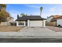 Charming single-story home with a well-maintained front yard and a two-car garage at 4046 Bridgeview Cir, Las Vegas, NV 89147