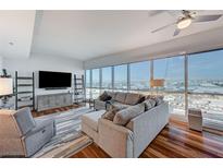 Bright living room featuring hardwood floors, large windows, and comfortable seating at 4525 Dean Martin Dr # 1208, Las Vegas, NV 89103