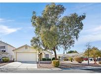 Charming home featuring well-maintained front yard, mature landscaping, and an attached two-car garage at 5429 Sweet Shade St, Las Vegas, NV 89130