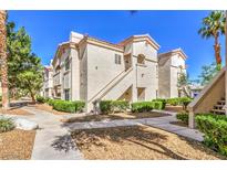 Charming condominium complex featuring well-maintained landscaping and stucco facade with a tile roof at 6480 Annie Oakley Dr # 624, Las Vegas, NV 89120