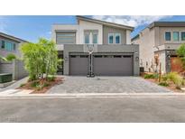 Contemporary two-story home featuring a two-car garage and landscaped front yard at 681 Stone Hammer Ave, Las Vegas, NV 89183