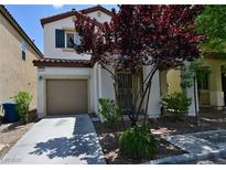 Charming two-story home featuring a well-manicured front yard and attached garage at 7089 Oberling Bay Ave, Las Vegas, NV 89113