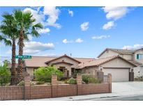 Charming single-story home featuring mature palm trees and a well-manicured front yard at 8021 Yellow Daisy Ave, Las Vegas, NV 89147