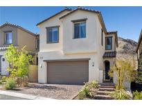 Charming two-story home showcasing a neutral exterior and a convenient two-car garage at 11652 Desert Hollow Ave, Las Vegas, NV 89138