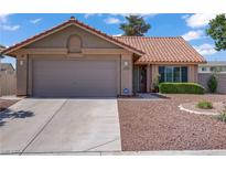 Charming single-story home featuring a well-maintained front yard and a two-car garage at 1219 Heather Oaks Way, North Las Vegas, NV 89031