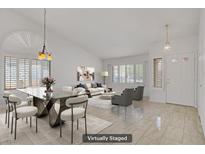 Bright living room with dining area, tile floors, modern furniture, and natural light at 1219 Heather Oaks Way, North Las Vegas, NV 89031