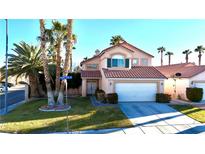 Charming two-story home with a well-maintained lawn and mature trees in a sunny neighborhood at 1515 Fort Dix Cir, North Las Vegas, NV 89031