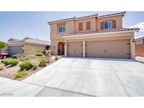 Two story home featuring a spacious two-car garage and well-maintained front yard landscaping at 1699 Sonoran Bluff Ave, Henderson, NV 89014