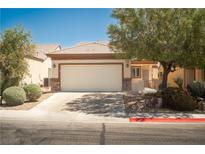 Charming single-story home featuring a two-car garage, desert landscaping, and a welcoming entrance at 2708 Cheer Pheasant Ave, North Las Vegas, NV 89084