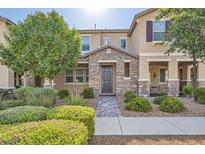 Charming two-story home with stone accents, a well-manicured yard, and a welcoming front entrance at 2878 Via Firenze, Henderson, NV 89044