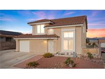 Charming two-story home featuring a tile roof, well-kept landscaping, and an attached garage at 3008 Soledad Dr, Laughlin, NV 89029